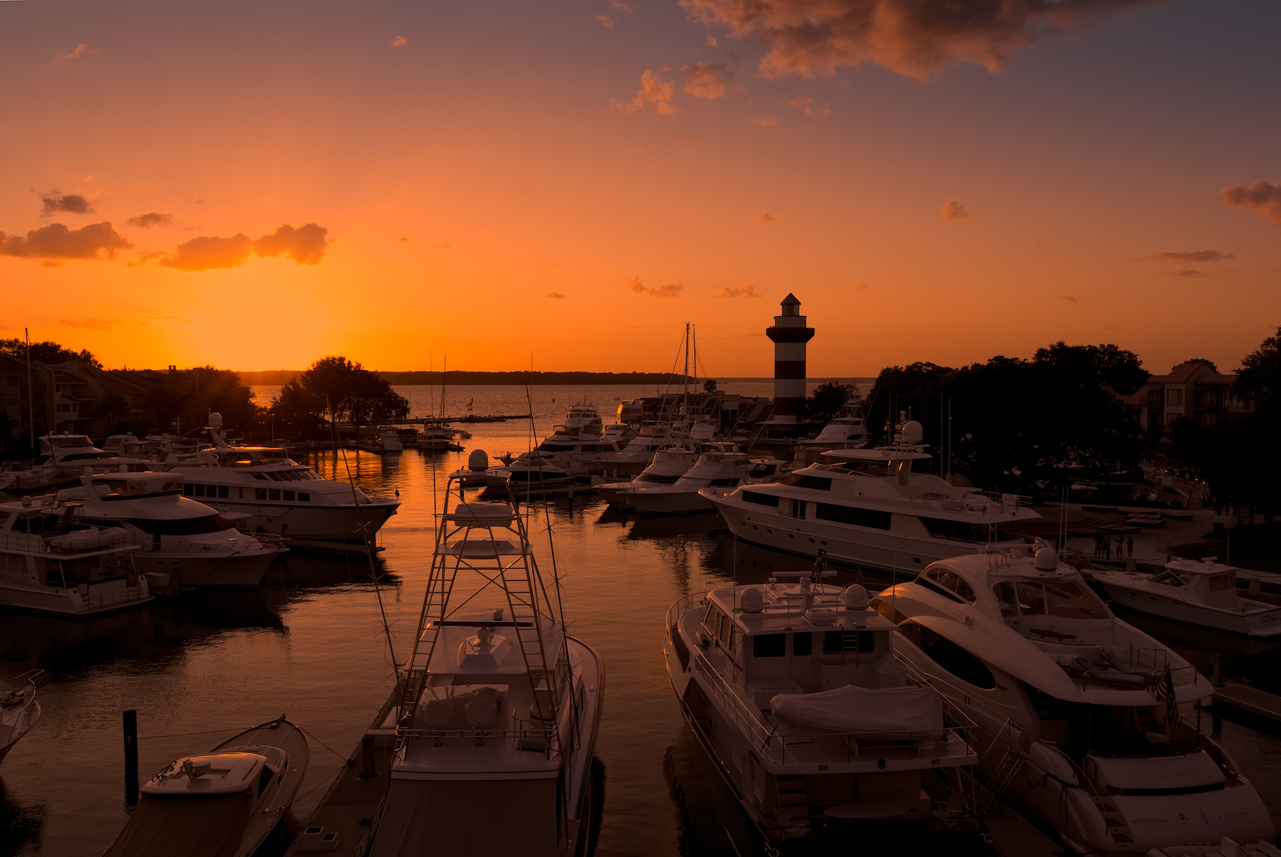 sunset on hilton head marina lighthouse in the background