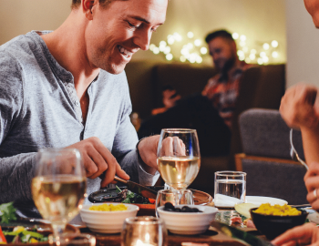 Friends dining together at table