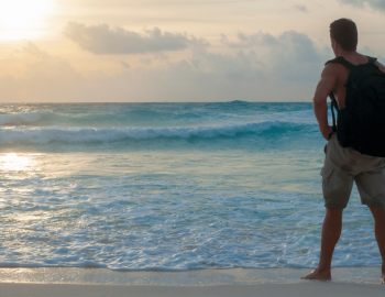 man hiking on beach