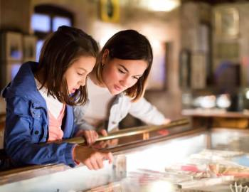 A mother and daughter examining artifacts at a Hilton Head museum