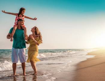 A family walking the beach on Hilton Head Island, one of the island's best things to do with kids