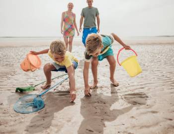 A family playing on the beach in Hilton Head during low tide