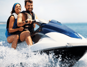 Happy couple riding on jet ski 