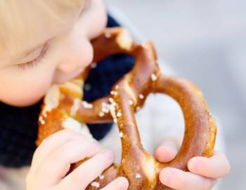 child eating pretzel at oktoberfest 