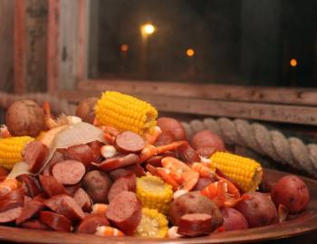 A boil with crawfish, sausage, corn, onions, and more; a great example of Lowcountry cuisine