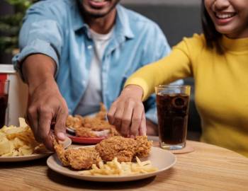 A couple enjoying chicken tenders at Lucky Beach Bar And Kitchen on Hilton Head Island