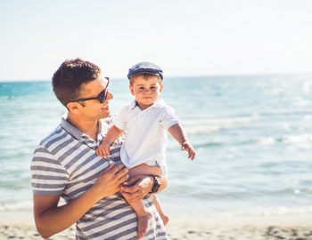 father on beach with son