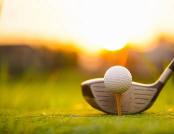 Close up of golf club and golf ball on a tee