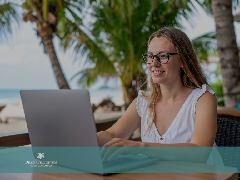 Woman on Laptop Working Near Beach