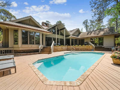 Single family vacation home in front of pool with blue skies. 