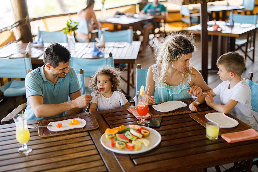 family at breakfast at beach restaurant